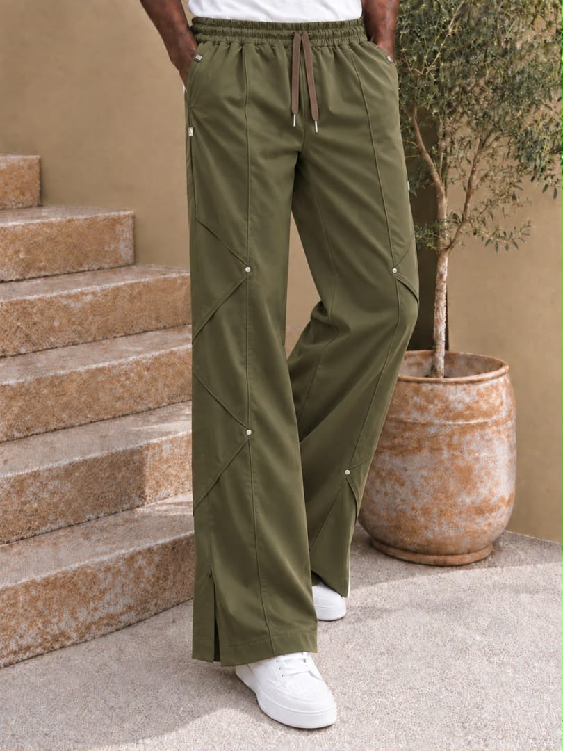 Pantalon large à coutures diagonales et rivets