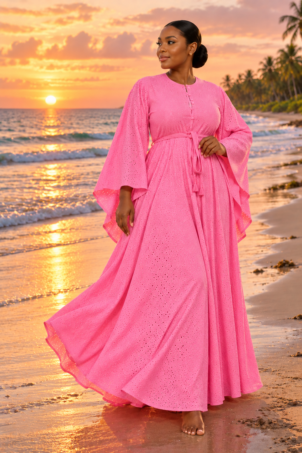 Robe longue rose en broderie anglaise sur la plage au coucher du soleil