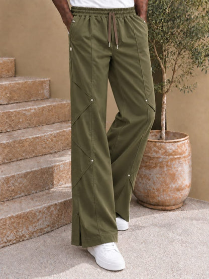 Pantalon large à coutures diagonales et rivets