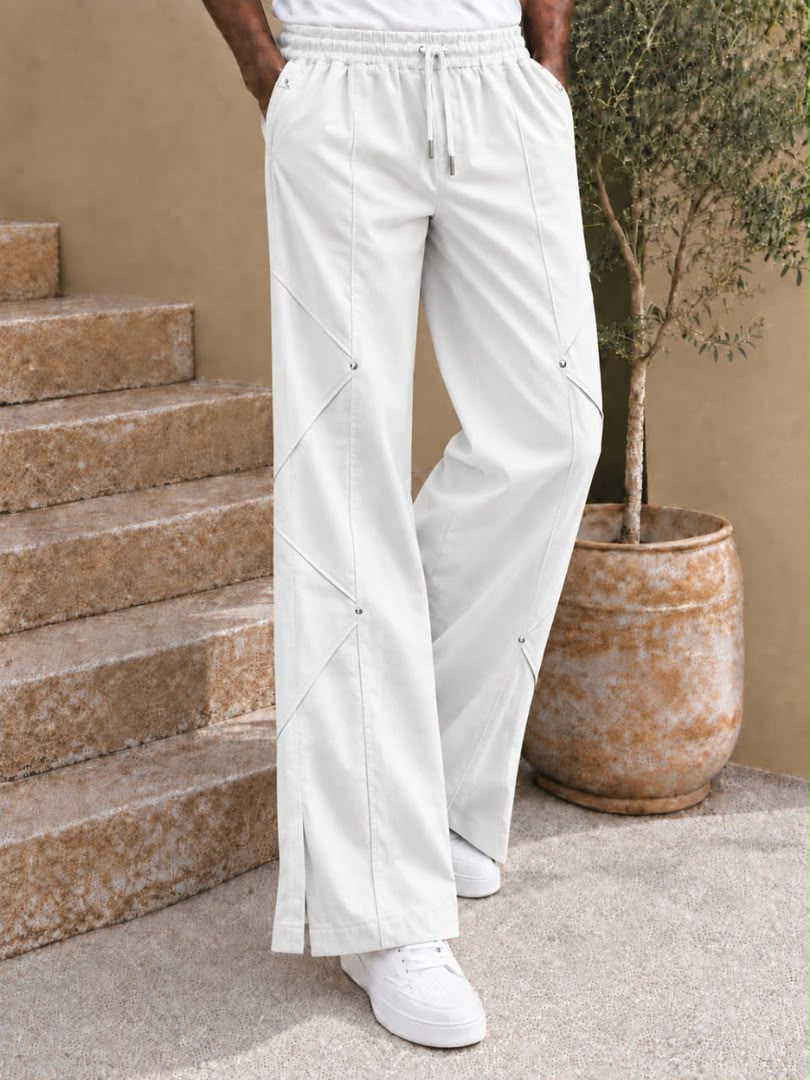 Pantalon large à coutures diagonales et rivets