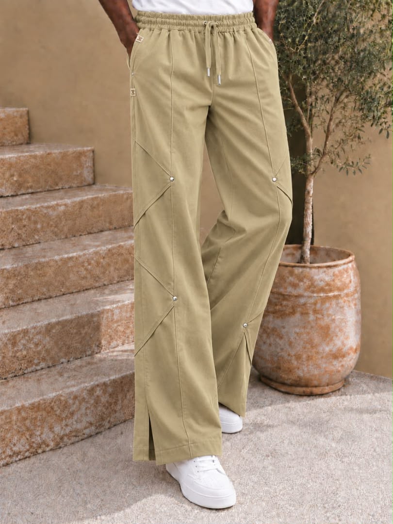 Pantalon large à coutures diagonales et rivets